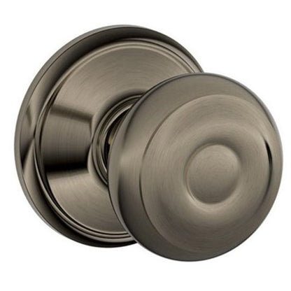 Close-up of the Schlage Georgian-style non-locking passage door knob, highlighting its Antique Pewter finish and classic design.